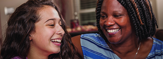 Volunteer laughing with child